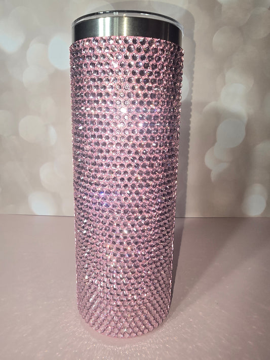 20oz skinny tumbler fully covered in blush pink rhinestones, sparkling against a soft background
