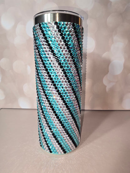 20oz skinny tumbler fully covered in teal, clear, and black rhinestones in a zebra stripe pattern